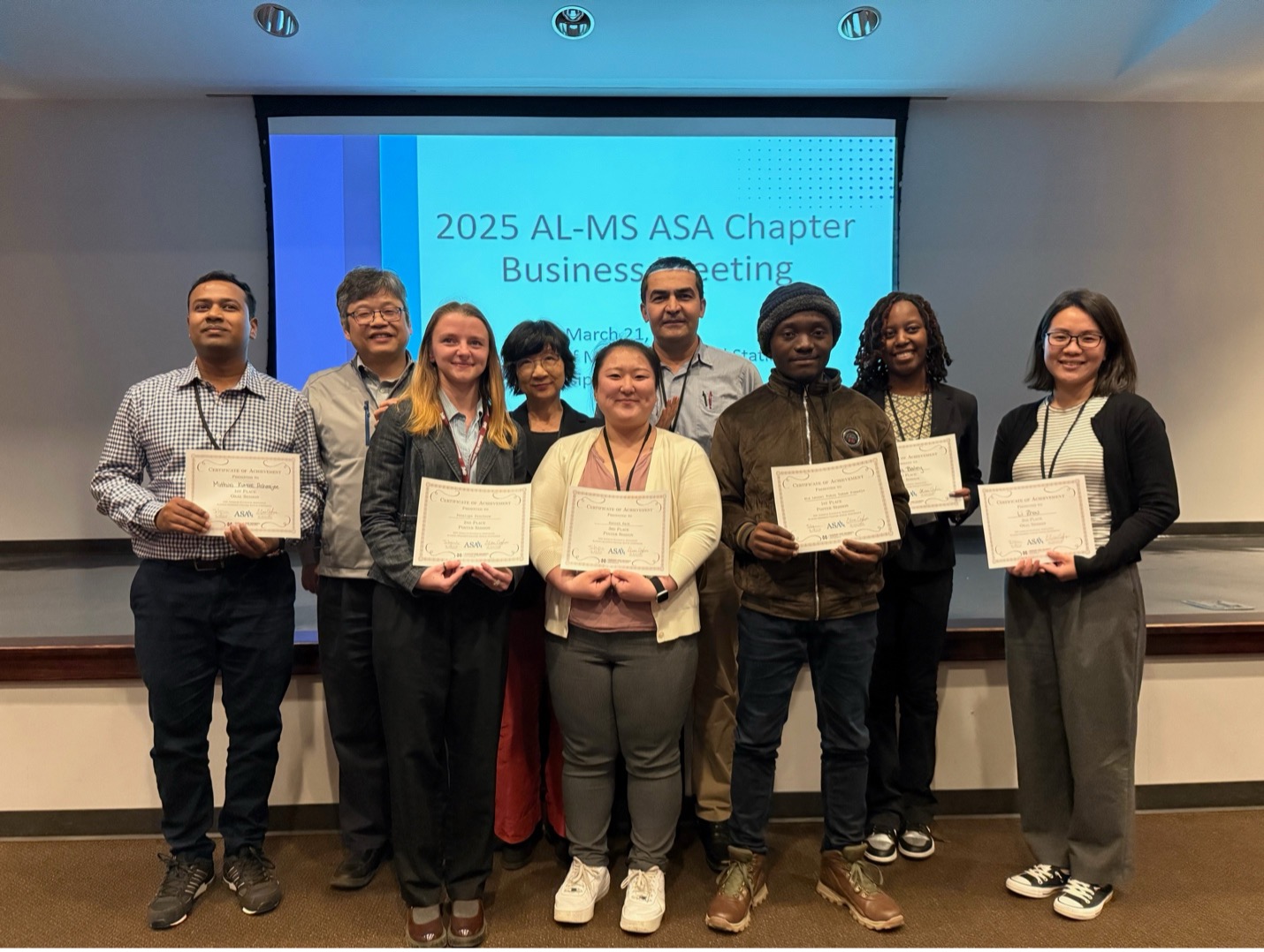 Drs. Ji-Hyun Lee and Peter Song present award certificates to the student winners of the poster and presentation sessions.